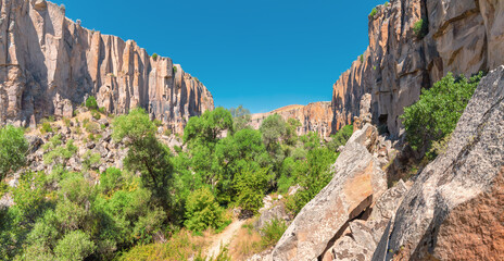 Fototapeta na wymiar Famous and popular tourist attraction of Cappadocia and Turkey is the Ihlara Valley with a deep gorge and steep cliffs with hiking paths