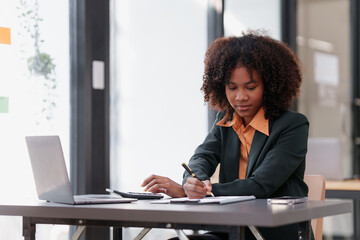 Accountant black woman working on laptop and do document, tax, exchange, accounting and Financial advisor concept