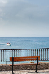 An empty bench with a view at the sea
