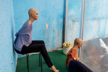 Abandoned female mannequins in a shabby shop window. Discrimination against women, loss of...