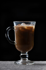 Preparation of cold coffee. Coffee and milk are poured into a glass with ice
