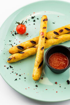 Grilled German sausages with hot tomato sauce