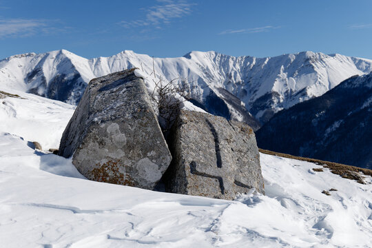 Stecci Medieval Tombstones Graveyards in Lukomir village, Bosnia and Herzegovina. The tombstones feature a wide range of decorative motifs and inscriptions. Winter and snow.
