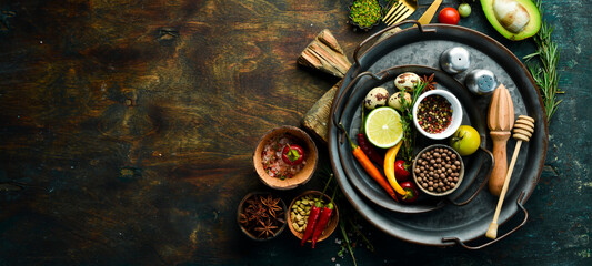 Spices, vegetables and herbs on a metal tray. Food background. Top view. Rustic style.