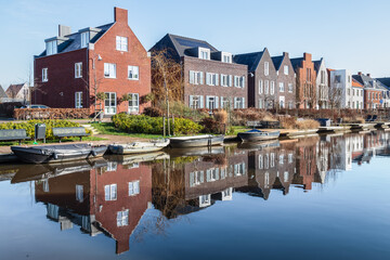 New modern residential buildings along the canal in the Vathorst district in Amersfoort. - obrazy, fototapety, plakaty