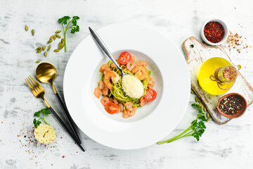Pasta with shrimp, cheese and pesto sauce. Italian cuisine. Menu. Top view.