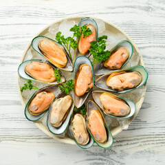 Raw green large mussels with spices on ice. The clams are ready for dinner. Free space for text.