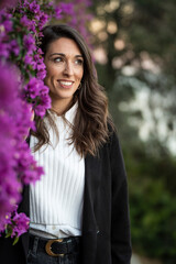 Portrait of a mid age woman near some violet flowers