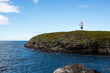 Fototapeta na wymiar Beautiful natural landscape of Norway with a lighthouse. Scenic outdoor view. Ocean with waves and mountains. Explore Norway, Lofoten Islands