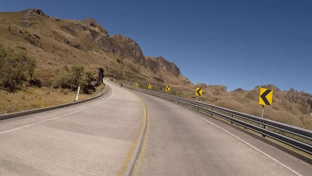 Andean highway that shows beautiful paramo landscapes, with wide shoulders to drive comfortably on a sunny day with little cloudiness