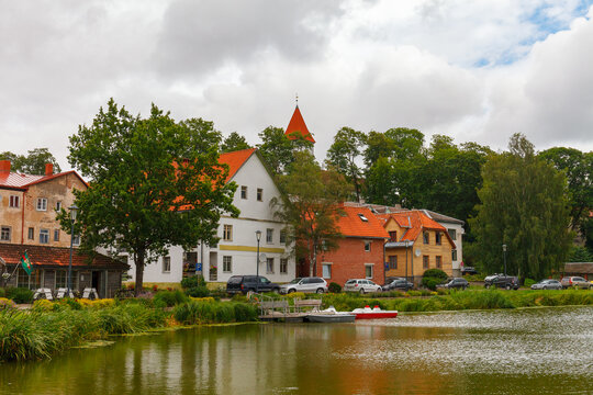 TALSI, LATVIA, SEPTEMBER 10, 2022: Colorful old town houses and church with lake reflection in Talsi Latvia.