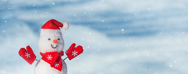 Christmas winter banner with a snowman in a santa hat on his head in a winter fores. Holiday...
