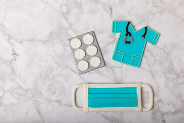 Doctor's Day greeting card with gingerbread on a marble background. Cookies for the day of the doctor in the form of medical equipment. Concept of healthcare and medicine.