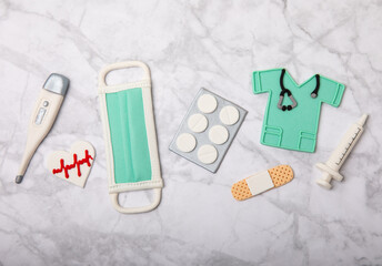 Doctor's Day greeting card with gingerbread on a marble background. Cookies for the day of the doctor in the form of medical equipment. Concept of healthcare and medicine.