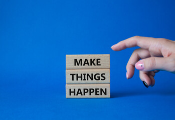 Make things happen symbol. Concept word Make things happen on wooden blocks. Businessman hand. Beautiful blue background. Business and Make things happen concept. Copy space