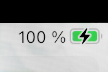 Smartphone full charged pixel battery level indicator - charging process - one hundred, 100 percent: close up, macro of gadget display, screen. Energy, technology, power, digital and symbol concept