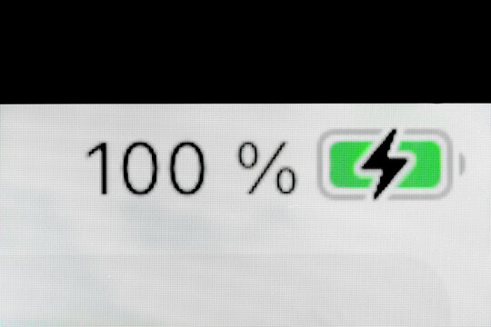 Smartphone full charged pixel battery level indicator - charging process - one hundred, 100 percent: close up, macro of gadget display, screen. Energy, technology, power, digital and symbol concept