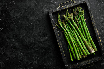 Organic food. Green asparagus in a wooden box. Top view.