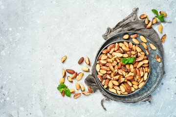 Nuts. Brazil nut on a stone background. Top view. Free space for text.