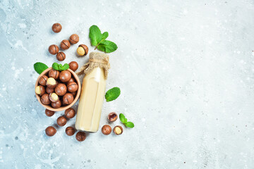 Macadamia. Milk is made from macadamia nuts. On a stone background. Top view. Free space for text.
