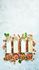 Almond milk in a bottle. Nut milk and almond nuts. Dairy-free milk replacer, healthy food. Free space for text.