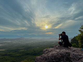 The photographer sits and looks at the sea of clouds. in Nakhon Si Thammarat Province