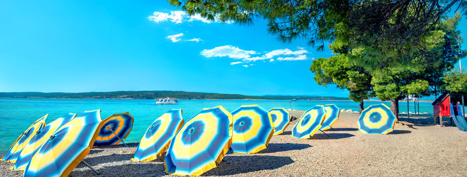 View of  small beach with lying umbrellas in Crikvenica town. Kvarner bay, Croatia