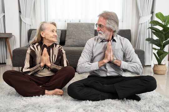 Portrait Couple Caucasian Older Training Yoga Meditate At Home	