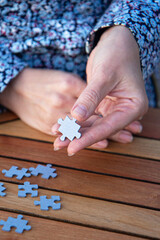 Woman is holding puzzle pieces in her hands. Business decisions, success and strategy concept