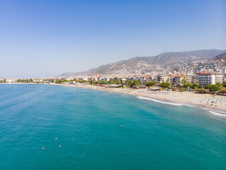 Fototapeta na wymiar Top view of the tourist city of Alanya located between the mountains and the sea in Turkey, on a sunny summer day