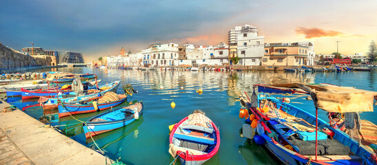 Colourful boats in old fishing port of Bizerte at sunset. Tunisia, North Africa