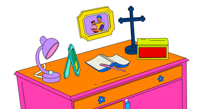 Orange desk with a book, pen, crucifix, lamp, jewellery box and framed family photograph of a dad and daughter