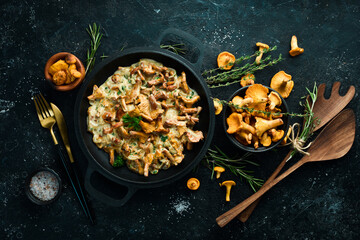 Mushroom dishes. Cooked chanterelle mushrooms in a cream sauce. Top view. Free space for text. - obrazy, fototapety, plakaty