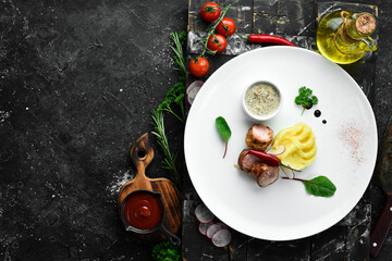 Fried sausage and mashed potatoes with sauce on a plate. Top view. Free space for text.