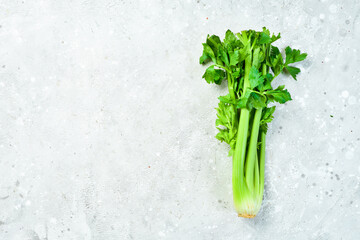 Celery. Fresh stalk of celery on a stone background. Healthy food. Top view. Free space for text.