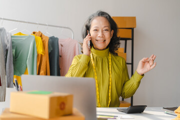 Elderly Asian business woman home office SMEs owner of online clothing store. and fashion designer, social media influencer