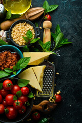 Pesto sauce with sun-dried tomatoes in a bowl. Traditional Italian sauce. On a concrete background.