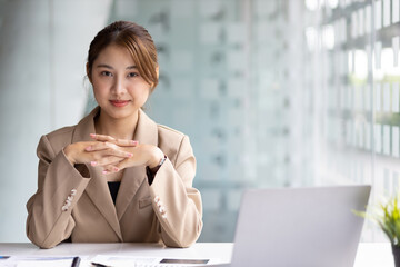 Portrait of an attractive smiling Asian businesswoman happy in the office.