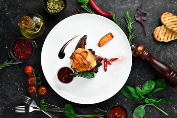 Buffalo chicken wings with sauce and potato chips on a plate, restaurant serving. Top view. Free space for text.