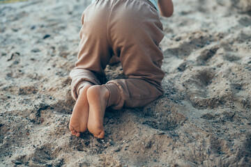 Four year old boy playing in a garden on a beautiful summer day. Summer day in nature. Summer outdoors activity for kids.