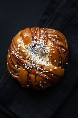  Traditional twisted Swedish cinnamon bun (Kanelbullar) on a dark background