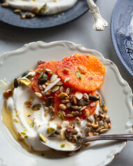 Breakfast Plate Consisting of Fresh Blood Orange Slices, Greek Yogurt, Honey and Roasted Nuts and Seeds