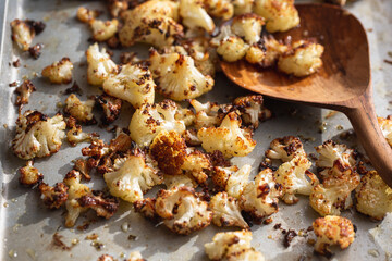 Roasted cauliflower florets in the oven on a baking sheet pan