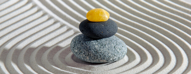 Japanese zen garden with stone in textured sand