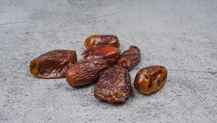 Dried sliced date fruit (Kurma) on cement texture background