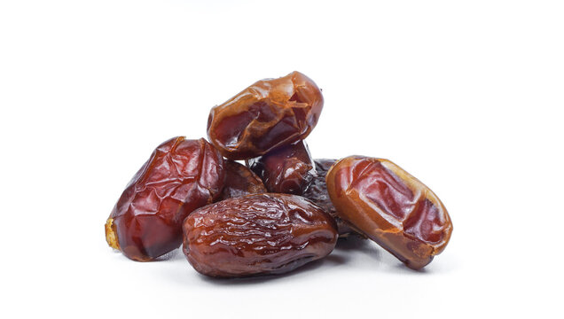 Dried sliced date fruit on white background with copy space. Snack vegan sugarfree food.