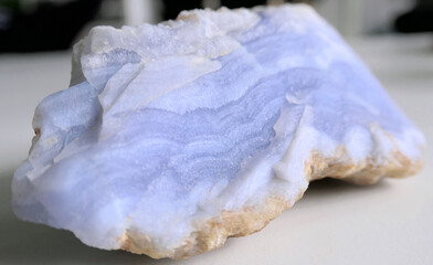 Piece of natural raw blue lace agate crystal with beautiful violet stripes