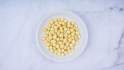 A bowl of chickpeas on marble texture backgound