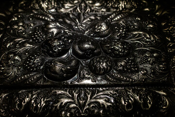 Blackened silver background. Decoration pattern. Jewelry texture. Floral engraving. Precious metal....