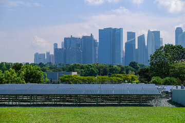 View of solar panels in foreground with modern cityscape in the background. Sustainability in the...
